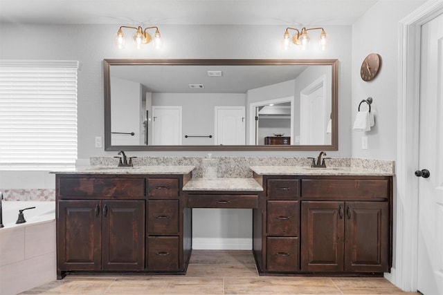 full bathroom featuring double vanity and a bath