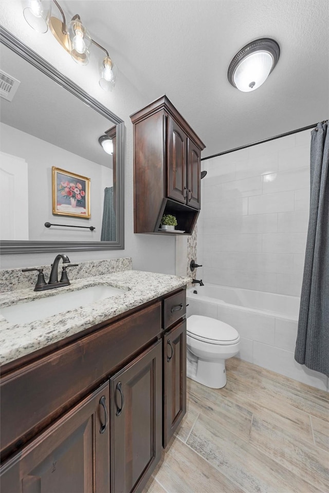 full bathroom featuring toilet, wood finished floors, vanity, and shower / bathtub combination with curtain