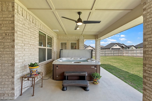 view of patio with a hot tub and ceiling fan