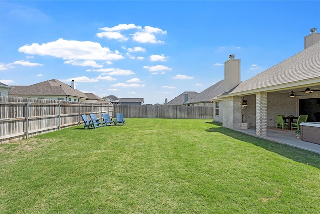 view of yard featuring ceiling fan and a patio