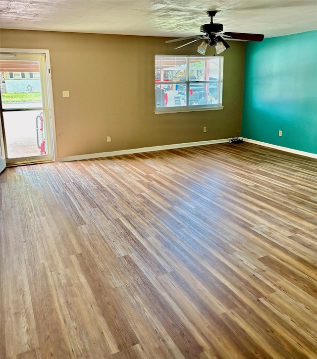 2142 Woodard St, Abilene, TX 79605 - empty room featuring wood finished floors, a ceiling fan, and baseboards