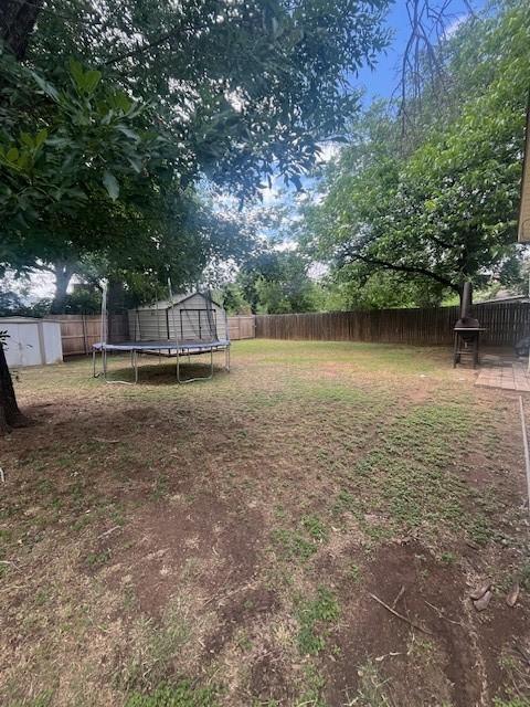 2142 Woodard St, Abilene, TX 79605 - view of yard with a trampoline