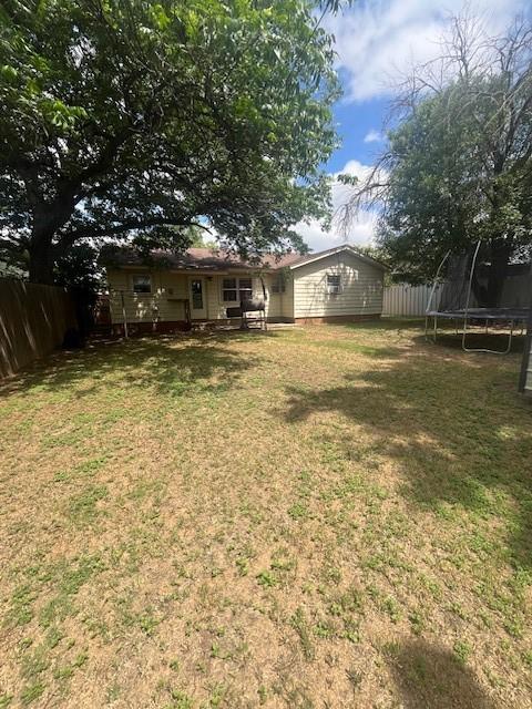 2142 Woodard St, Abilene, TX 79605 - view of yard featuring a trampoline
