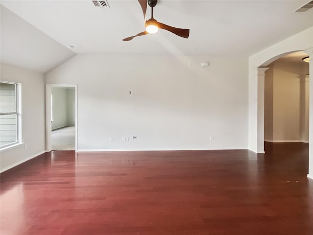 825 Lake Worth Trl, Little Elm, TX 75068 - unfurnished living room featuring arched walkways, ceiling fan, decorative columns, wood finished floors, and vaulted ceiling