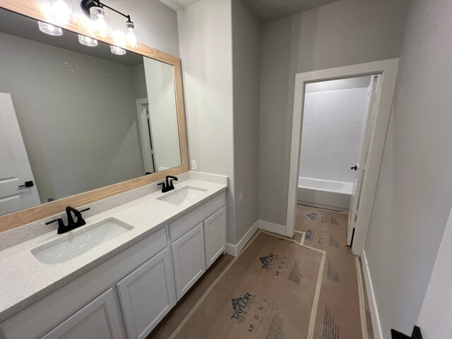 317 Magnolia Ln, Westworth Village, TX 76114 - bathroom featuring double vanity, a tub to relax in, and baseboards