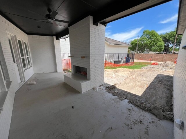317 Magnolia Ln, Westworth Village, TX 76114 - fenced backyard featuring an outdoor brick fireplace, a ceiling fan, and a patio area