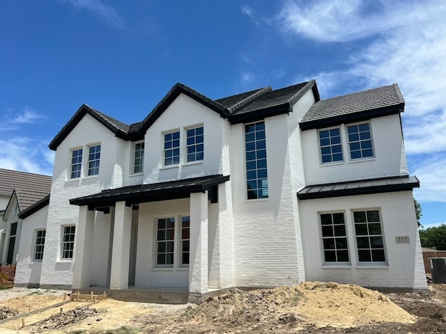 317 Magnolia Ln, Westworth Village, TX 76114 - modern farmhouse featuring brick siding, a standing seam roof, and cooling unit