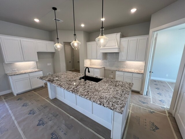 317 Magnolia Ln, Westworth Village, TX 76114 - kitchen featuring a sink, white cabinets, tasteful backsplash, premium range hood, and recessed lighting