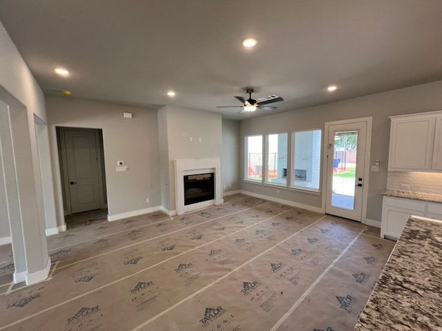 317 Magnolia Ln, Westworth Village, TX 76114 - unfurnished living room featuring a ceiling fan, recessed lighting, a glass covered fireplace, and baseboards