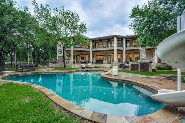 6645 Whispering Woods Ct, Plano, TX 75024 - outdoor pool featuring a water slide and a patio area