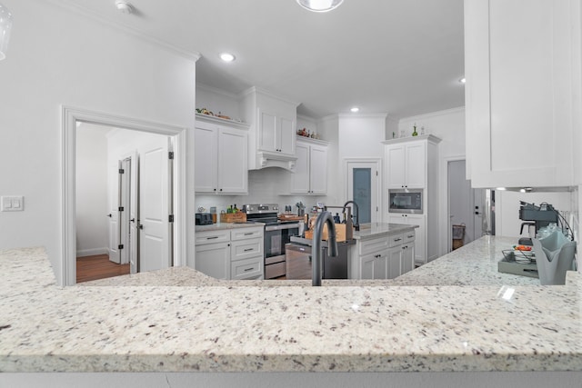 kitchen featuring stainless steel appliances, light stone countertops, white cabinetry, ornamental molding, and recessed lighting