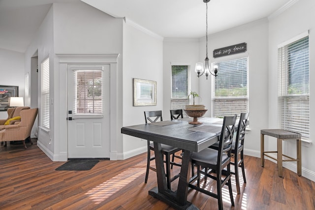 dining space with a chandelier, dark wood-type flooring, baseboards, and crown molding