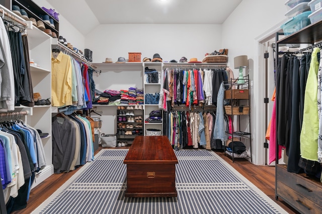 walk in closet featuring wood finished floors and vaulted ceiling