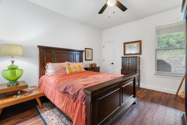 bedroom with baseboards, dark wood finished floors, and a ceiling fan