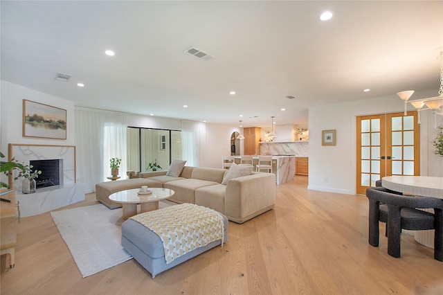3314 Norcross Ln, Dallas, TX 75229 - living room with a fireplace, recessed lighting, light wood finished floors, french doors, and baseboards