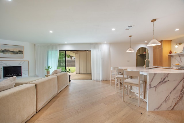 3314 Norcross Ln, Dallas, TX 75229 - living room featuring light wood-style floors, a fireplace, and recessed lighting