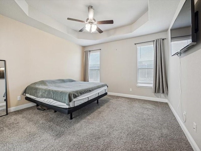 1044 Pitch Pine St, Hickory Creek, TX 75065 - carpeted bedroom featuring a raised ceiling, baseboards, and a ceiling fan