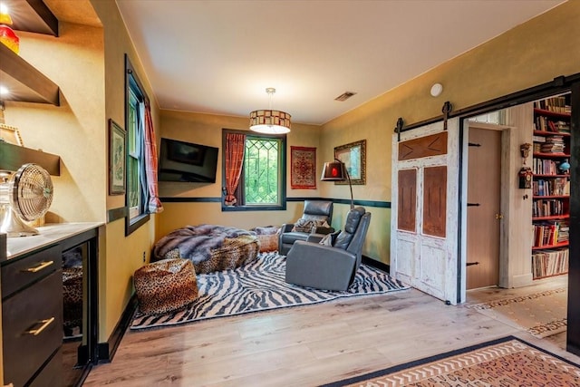 109 Mariah Dr, Weatherford, TX 76087 - sitting room featuring wood finished floors, a barn door, and wine cooler