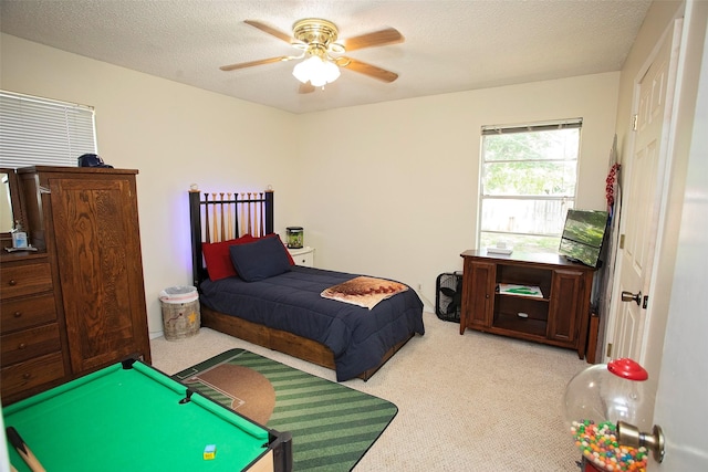1217 Randy Dr, Graham, TX 76450 - bedroom with light colored carpet, a ceiling fan, a textured ceiling, and billiards