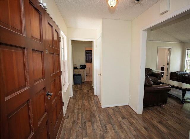 1217 Randy Dr, Graham, TX 76450 - corridor with a textured ceiling, dark wood finished floors, and baseboards
