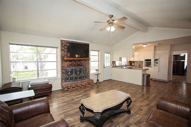 1217 Randy Dr, Graham, TX 76450 - living room with a ceiling fan, a fireplace, and dark wood-type flooring