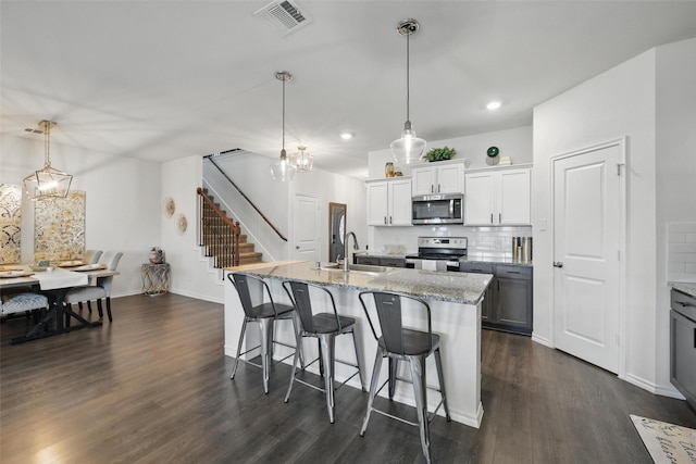 6213 Bracken Dr, Celina, TX 76227 - kitchen featuring stainless steel appliances, a sink, dark wood-style floors, tasteful backsplash, and recessed lighting