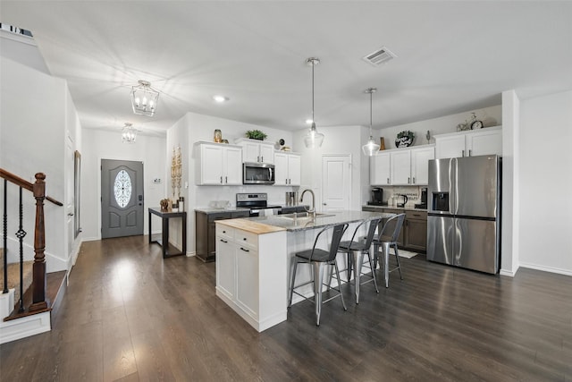 6213 Bracken Dr, Celina, TX 76227 - kitchen featuring appliances with stainless steel finishes, a sink, a kitchen bar, white cabinets, and dark wood-style flooring