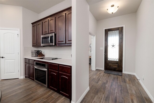 1705 Surrey Ct, Weatherford, TX 76087 - kitchen featuring stainless steel appliances, light countertops, dark wood-style floors, tasteful backsplash, and dark brown cabinetry