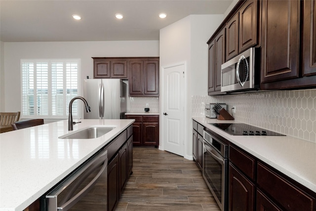 1705 Surrey Ct, Weatherford, TX 76087 - kitchen with stainless steel appliances, a sink, light countertops, recessed lighting, and dark brown cabinetry