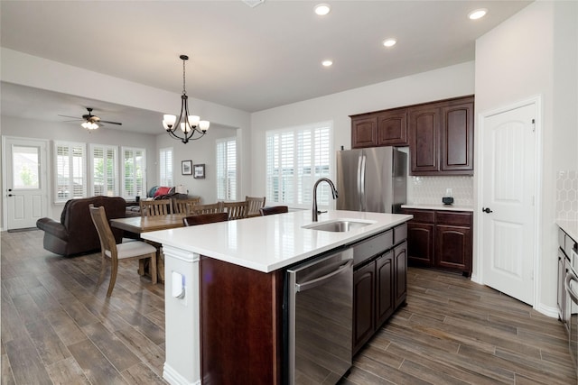 1705 Surrey Ct, Weatherford, TX 76087 - kitchen with a sink, appliances with stainless steel finishes, dark wood-type flooring, light countertops, and recessed lighting