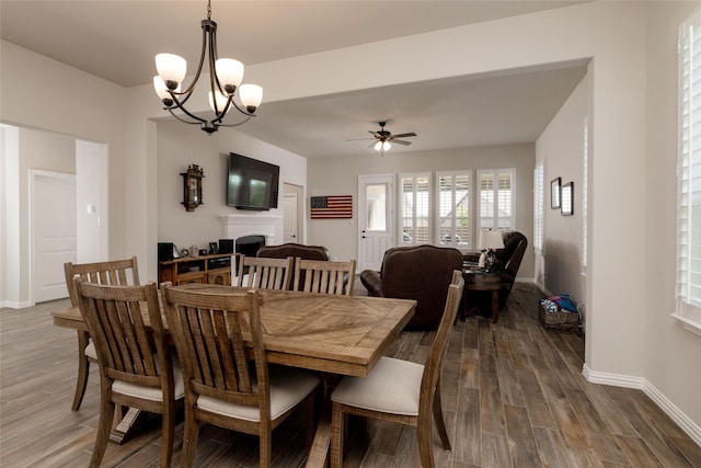 1705 Surrey Ct, Weatherford, TX 76087 - dining space featuring dark wood-style floors, baseboards, and a fireplace