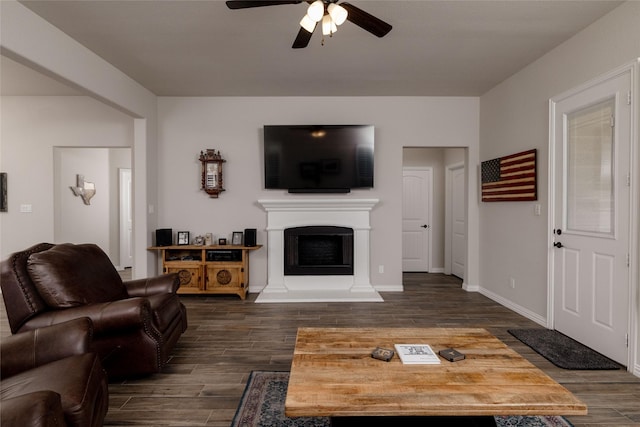 1705 Surrey Ct, Weatherford, TX 76087 - living area featuring a ceiling fan, dark wood finished floors, a fireplace with raised hearth, and baseboards