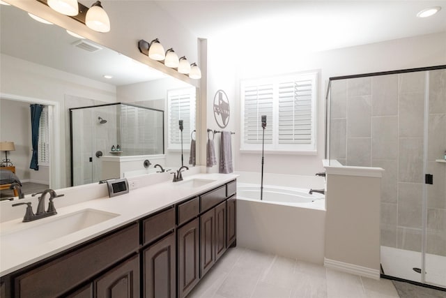 1705 Surrey Ct, Weatherford, TX 76087 - bathroom featuring a shower stall, a garden tub, tile patterned flooring, double vanity, and recessed lighting