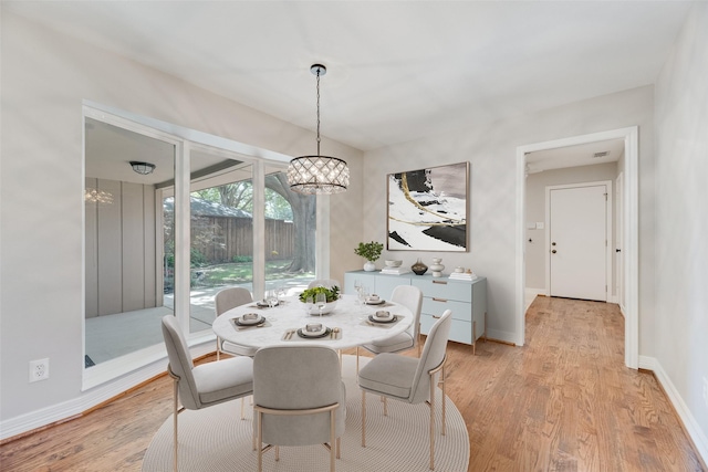 7324 Heathermore Dr, Dallas, TX 75248 - dining room with a chandelier, light wood-type flooring, and baseboards