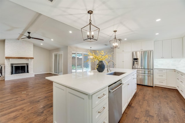 7324 Heathermore Dr, Dallas, TX 75248 - kitchen featuring appliances with stainless steel finishes, a sink, a ceiling fan, dark wood-style floors, and recessed lighting
