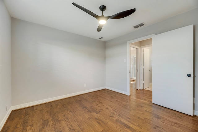 7324 Heathermore Dr, Dallas, TX 75248 - unfurnished bedroom featuring wood finished floors, baseboards, and ceiling fan