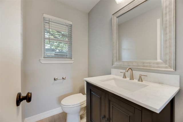 7324 Heathermore Dr, Dallas, TX 75248 - half bathroom featuring vanity, toilet, baseboards, and wood finished floors
