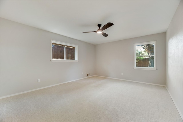 unfurnished room with light carpet, ceiling fan, and baseboards