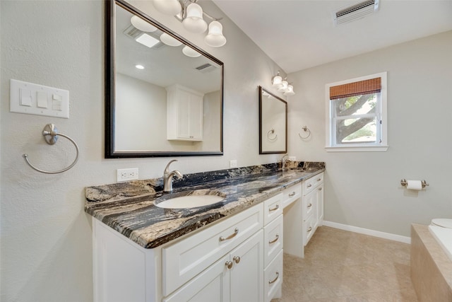 7324 Heathermore Dr, Dallas, TX 75248 - bathroom with double vanity, tile patterned floors, tiled tub, and baseboards