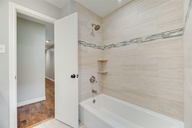 full bathroom featuring shower / bathtub combination, baseboards, and wood finished floors