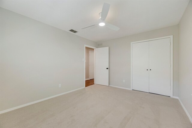 7324 Heathermore Dr, Dallas, TX 75248 - unfurnished bedroom featuring light carpet, baseboards, ceiling fan, and a closet