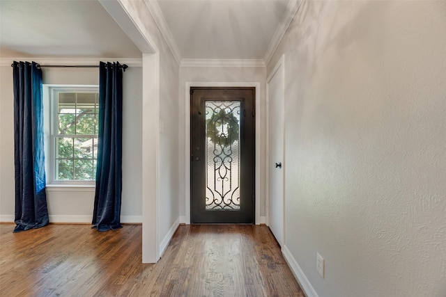 entrance foyer with wood finished floors, crown molding, and baseboards