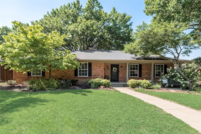 7324 Heathermore Dr, Dallas, TX 75248 - single story home with brick siding, a front yard, and a chimney