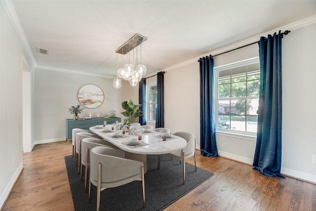 7324 Heathermore Dr, Dallas, TX 75248 - dining space with wood finished floors, a chandelier, crown molding, and baseboards