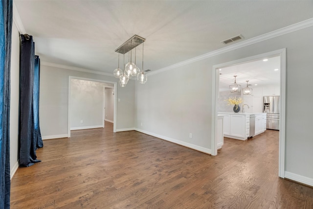 7324 Heathermore Dr, Dallas, TX 75248 - empty room with a chandelier, wood finished floors, crown molding, and baseboards