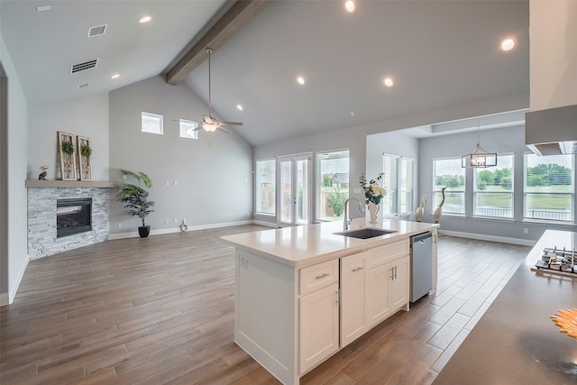 14312 Home Trl, Fort Worth, TX 76262 - kitchen with open floor plan, a sink, a ceiling fan, beam ceiling, and stainless steel appliances