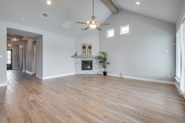 14312 Home Trl, Fort Worth, TX 76262 - unfurnished living room with high vaulted ceiling, a ceiling fan, a fireplace, beamed ceiling, and light wood-style floors