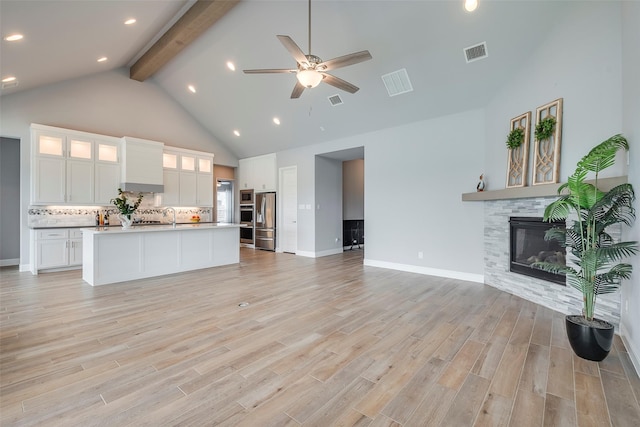 14312 Home Trl, Fort Worth, TX 76262 - kitchen with open floor plan, appliances with stainless steel finishes, beamed ceiling, high vaulted ceiling, and decorative backsplash