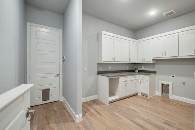14312 Home Trl, Fort Worth, TX 76262 - washroom with electric dryer hookup, cabinet space, light wood-style flooring, baseboards, and hookup for a gas dryer