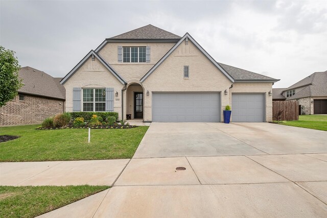 14312 Home Trl, Fort Worth, TX 76262 - view of front of house featuring driveway, a garage, brick siding, and a shingled roof